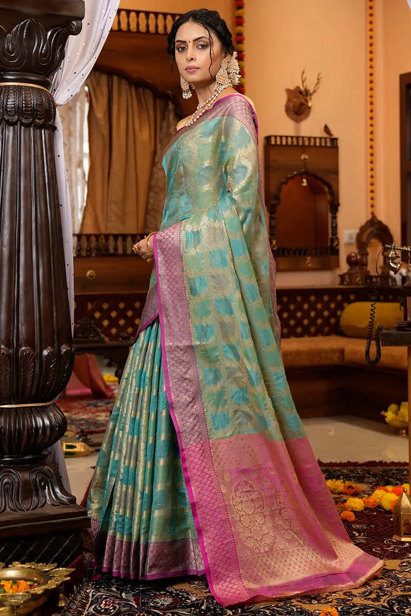 Cynosure Firozi Organza Silk Saree With Demesne Blouse Piece