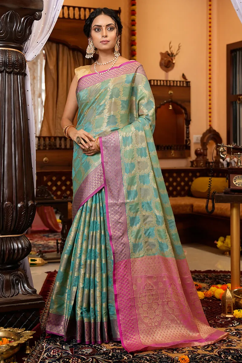 Cynosure Firozi Organza Silk Saree With Demesne Blouse Piece