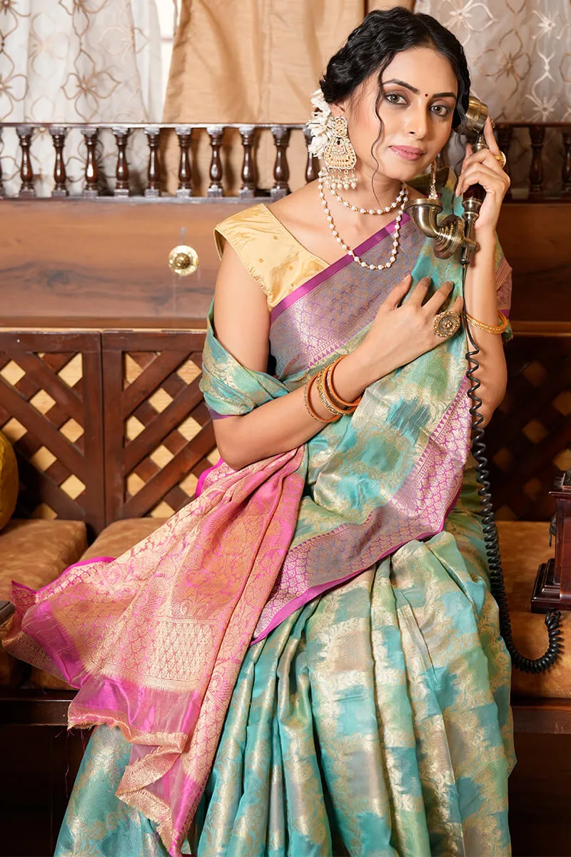 Cynosure Firozi Organza Silk Saree With Demesne Blouse Piece